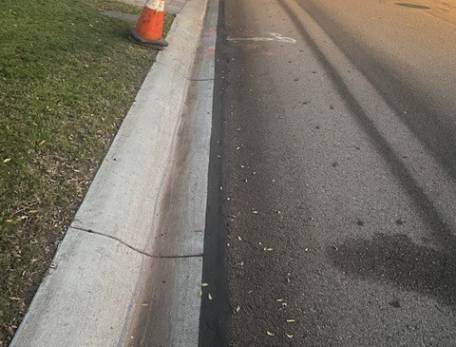 A reinstated trench next to the curb